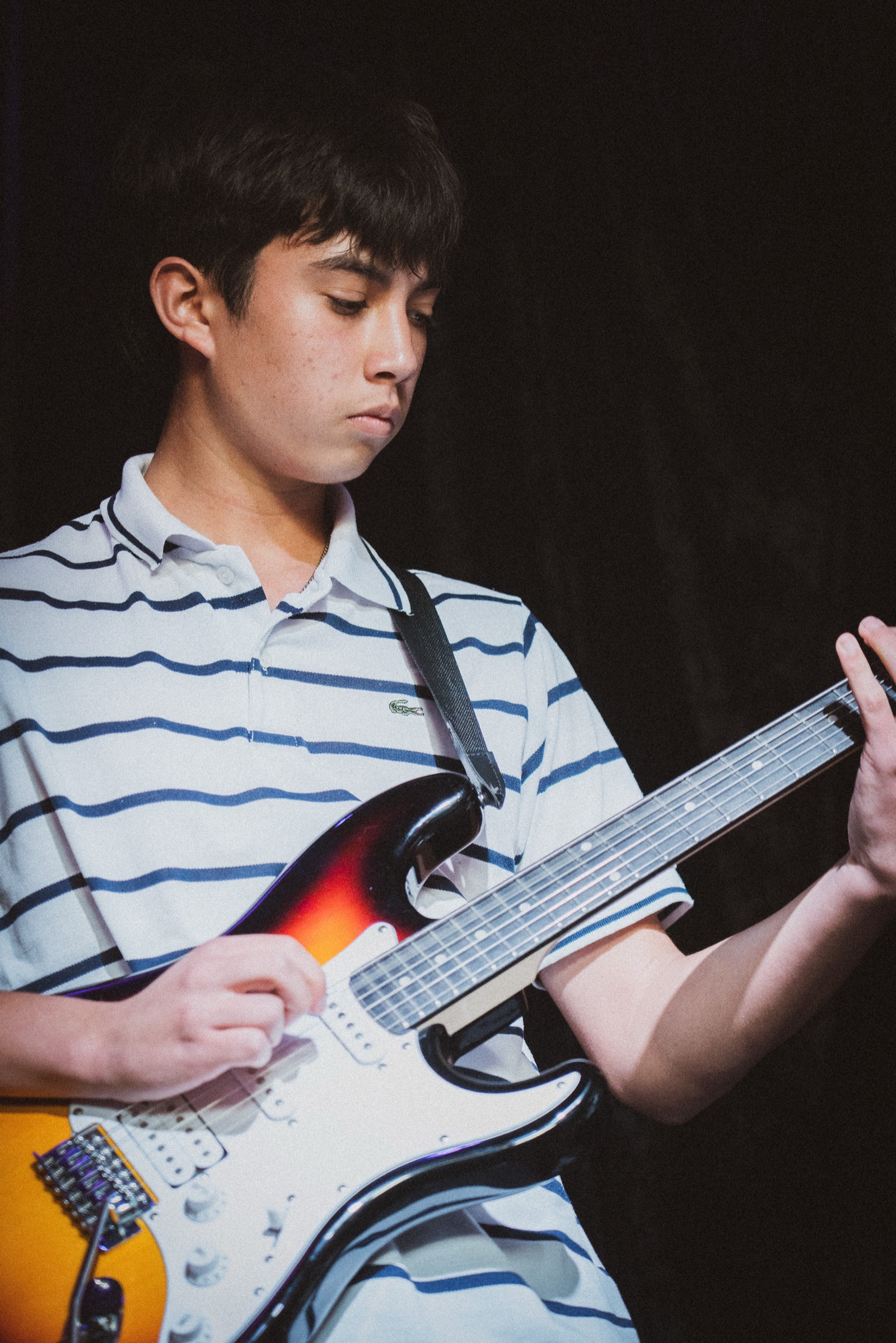 Guitarist in striped polo