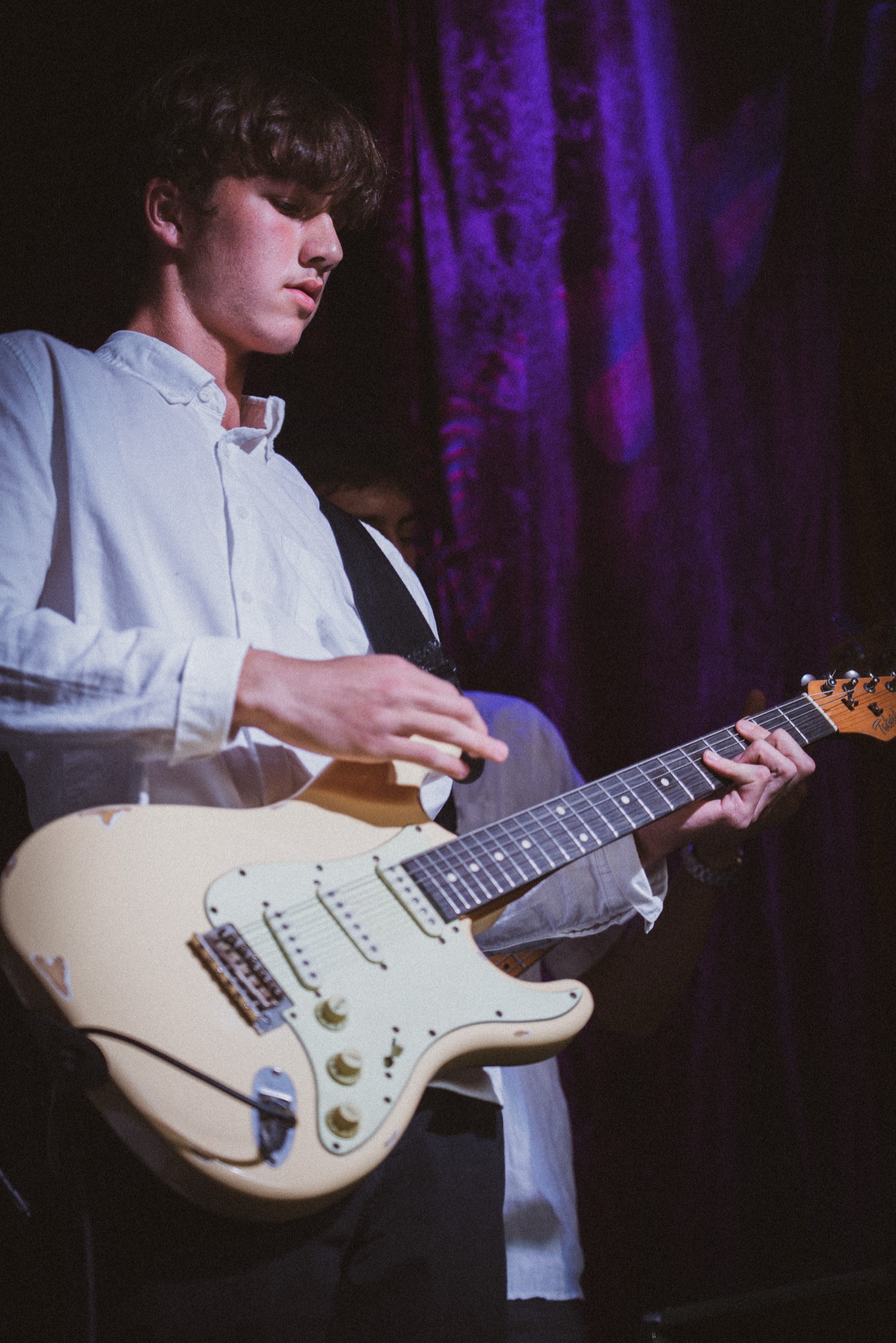 Guitarist playing white Strat