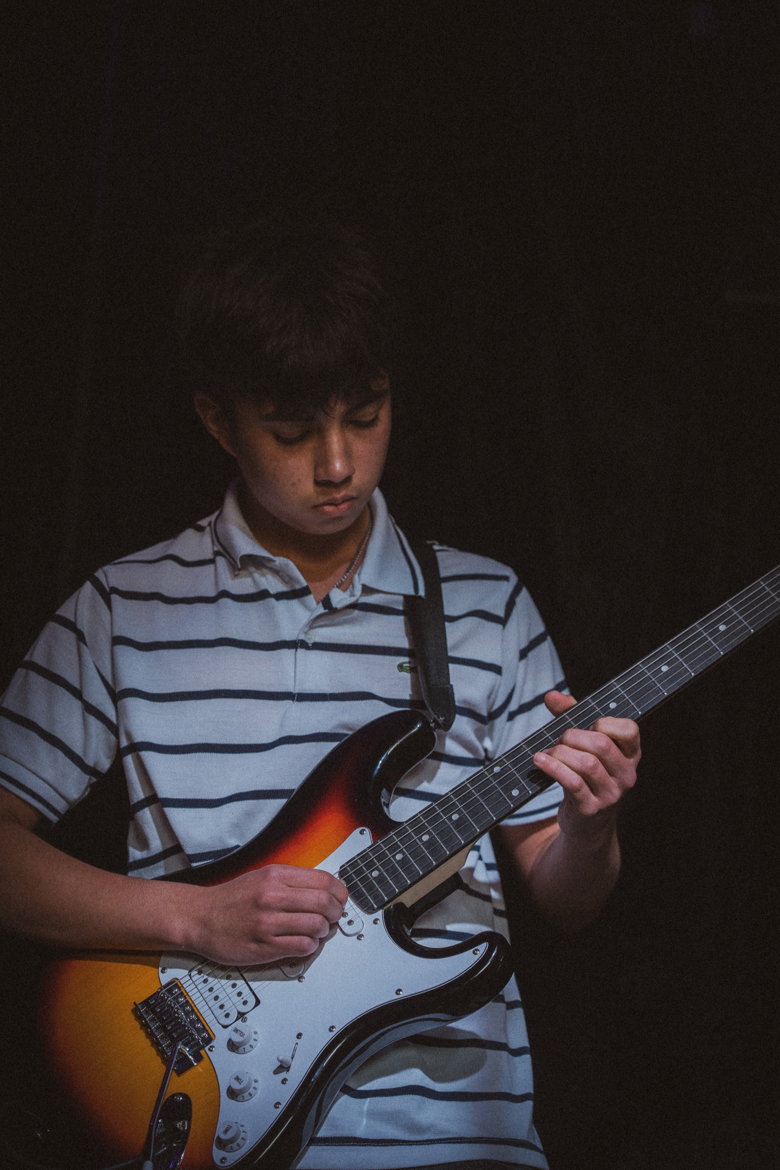 Guitarist in striped shirt