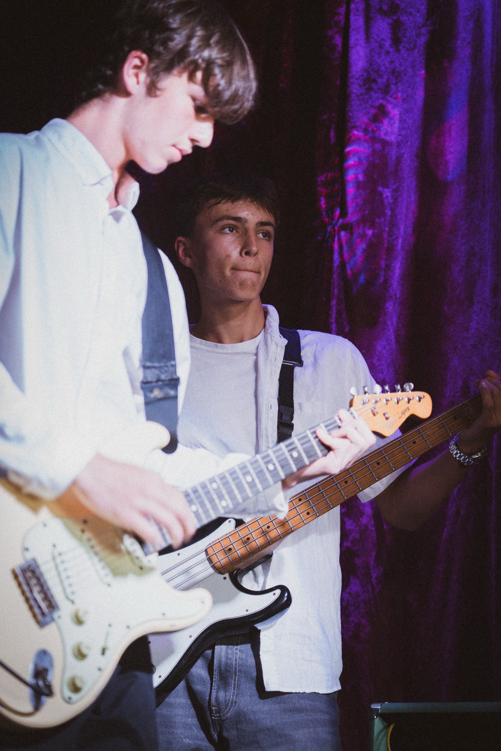 Two guitarists jamming on stage